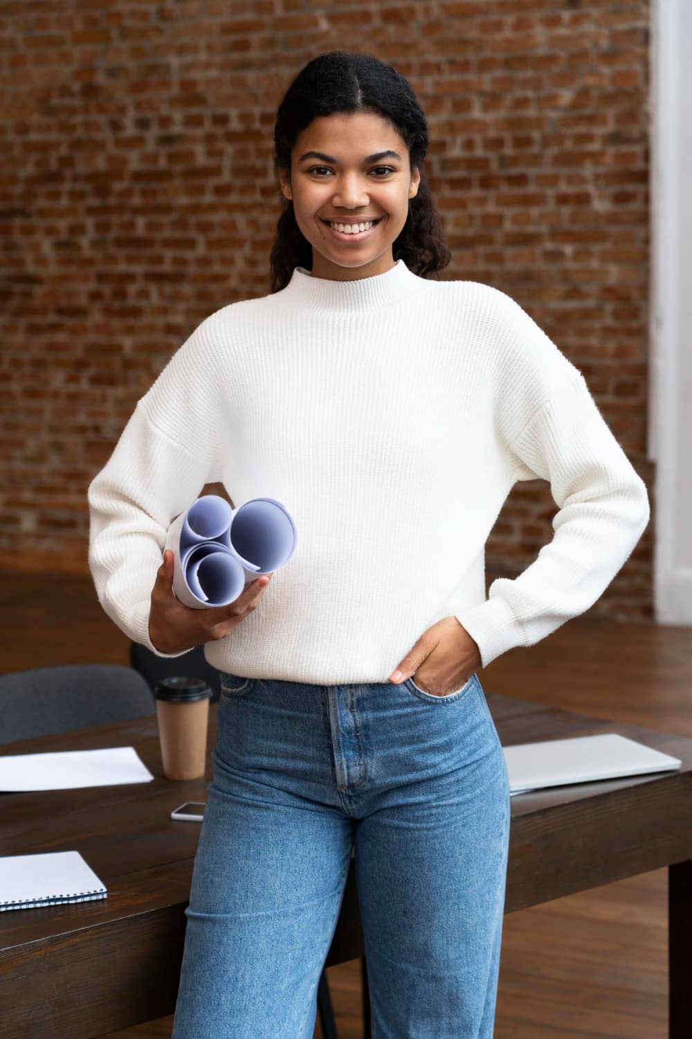 A business owner smiling at her laptop